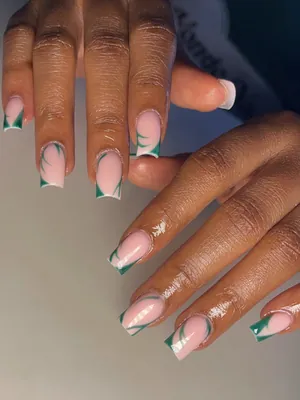 Nude French tip nails with green accents